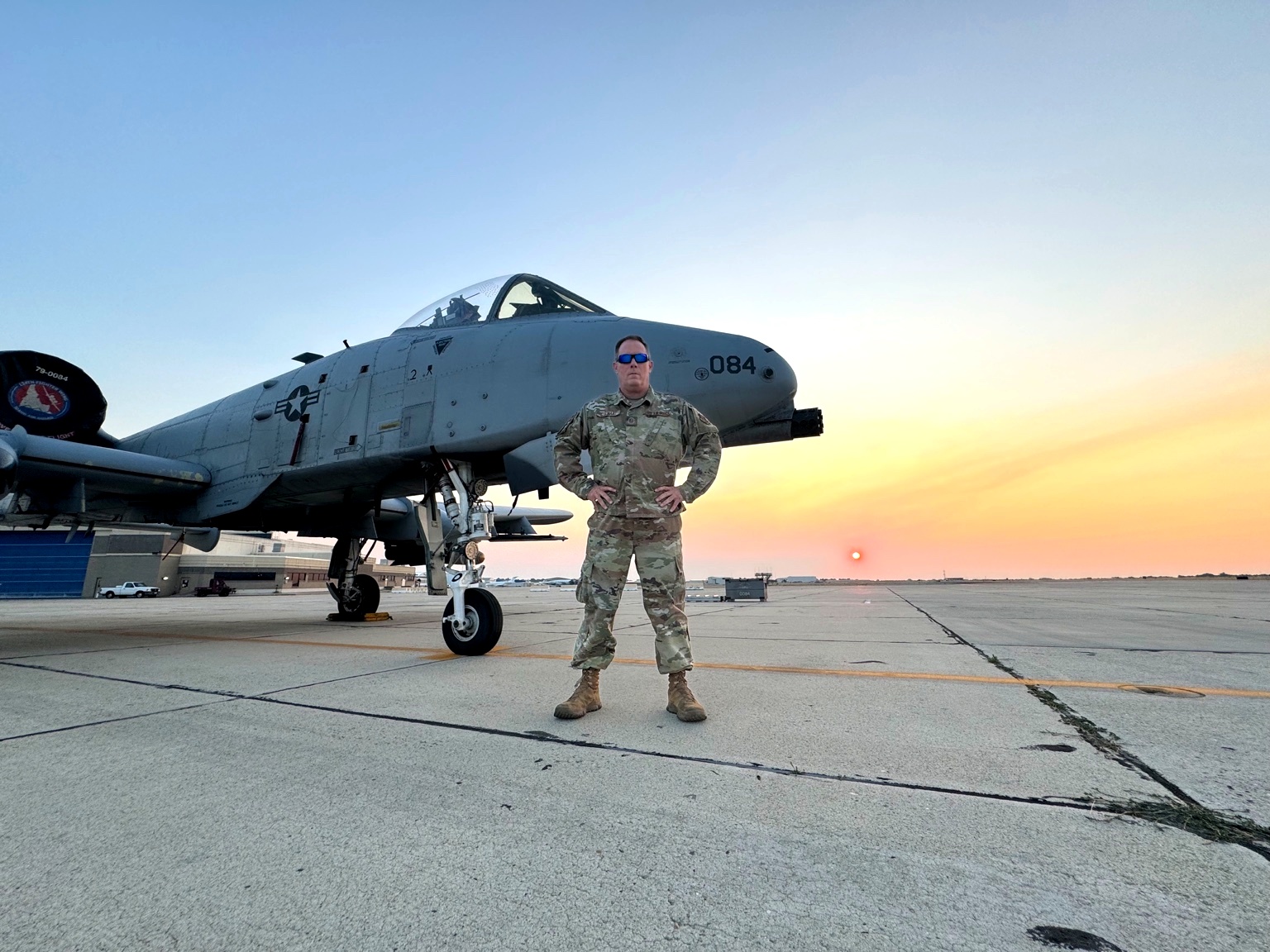 Chris standing beside an A-10 on the flightline